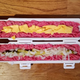 Sushi Bazooka chamber filled with raw meat, pickles, onions, and tiny rips of cheese